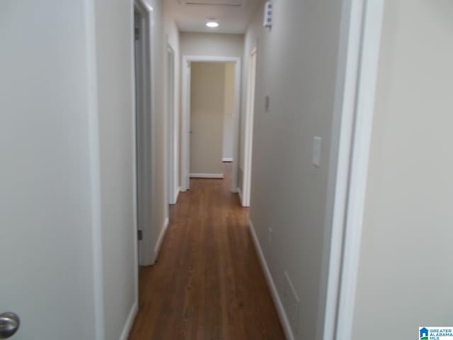 corridor featuring dark hardwood / wood-style flooring