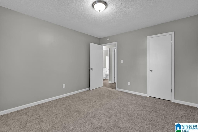 unfurnished bedroom with a closet, a textured ceiling, and carpet