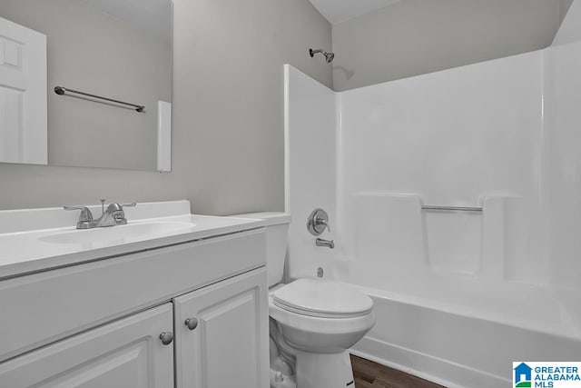 full bathroom featuring vanity, wood-type flooring, toilet, and shower / bath combination