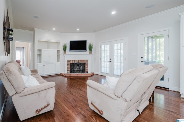 living room with crown molding, a fireplace, french doors, and dark hardwood / wood-style flooring