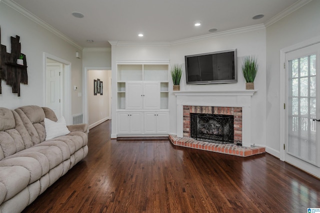 living room with dark wood-type flooring, ornamental molding, and a fireplace