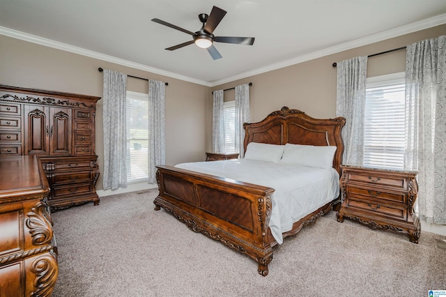 bedroom featuring crown molding, light colored carpet, and ceiling fan