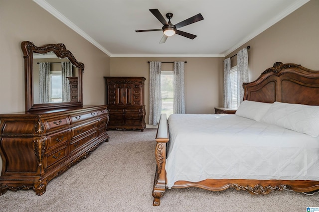 bedroom featuring crown molding, light colored carpet, and ceiling fan