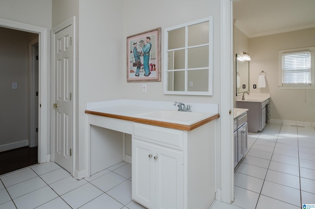 bathroom with vanity, ornamental molding, and tile patterned flooring