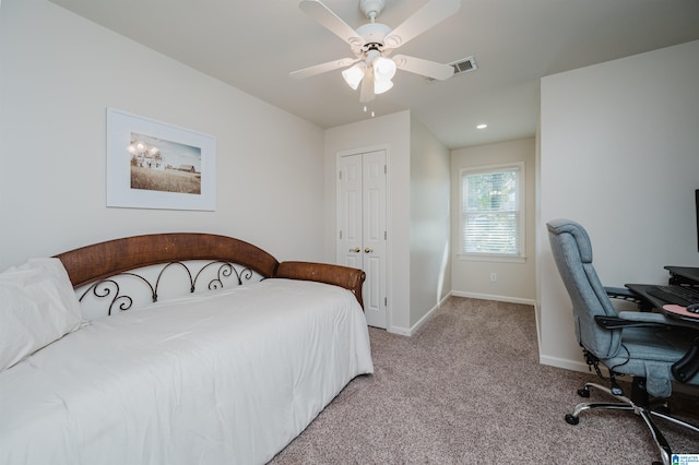 carpeted bedroom with a closet and ceiling fan