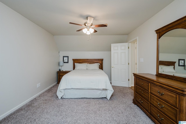 carpeted bedroom with vaulted ceiling and ceiling fan