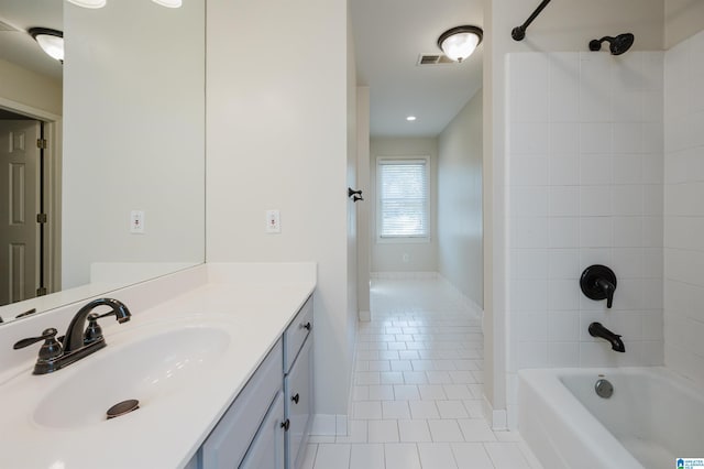 bathroom featuring tiled shower / bath, vanity, and tile patterned floors