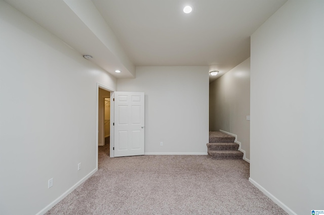 basement featuring light colored carpet