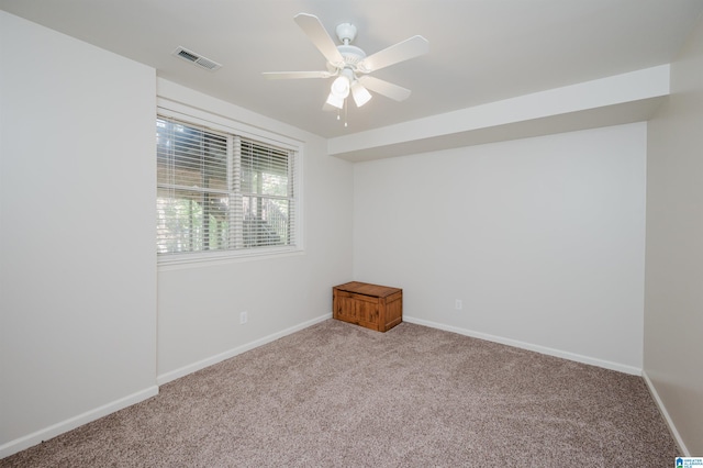 empty room with light colored carpet and ceiling fan