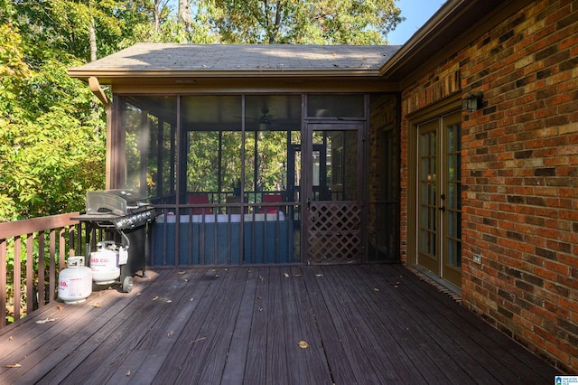 wooden terrace with a grill and a sunroom