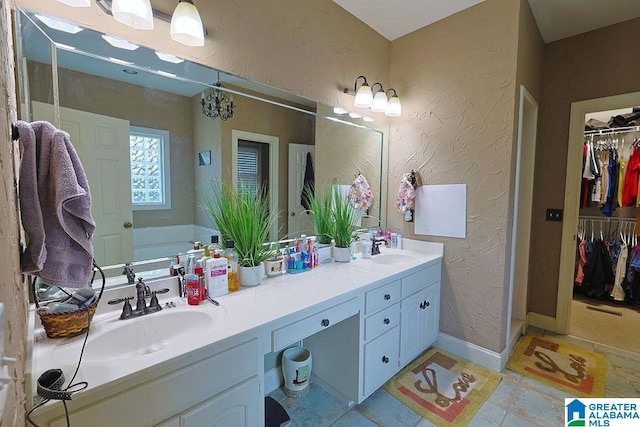 bathroom with vanity, a bath, and tile patterned floors