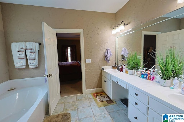 bathroom featuring vanity, a tub to relax in, and tile patterned floors