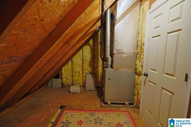 unfinished attic featuring heating unit