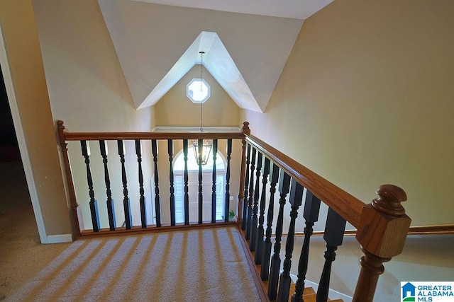 stairs featuring carpet flooring and vaulted ceiling