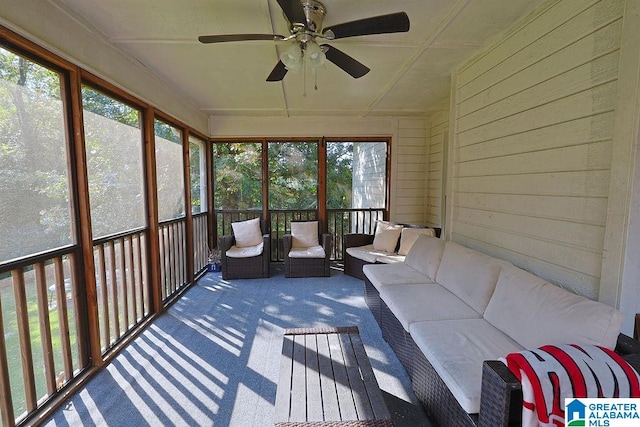 unfurnished sunroom featuring ceiling fan