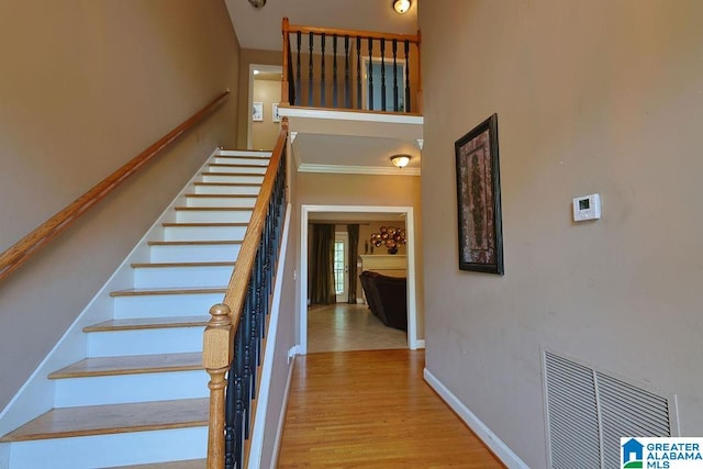 staircase with hardwood / wood-style flooring