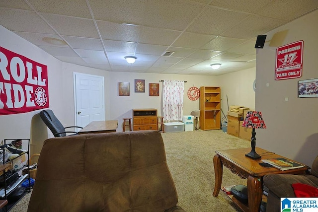 carpeted living room featuring a paneled ceiling