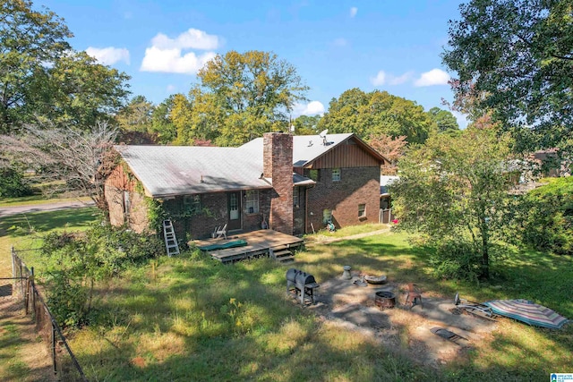 back of property with a deck and a lawn