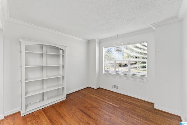 empty room with crown molding, a textured ceiling, and dark hardwood / wood-style flooring