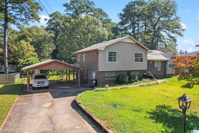 split level home featuring a carport and a front lawn