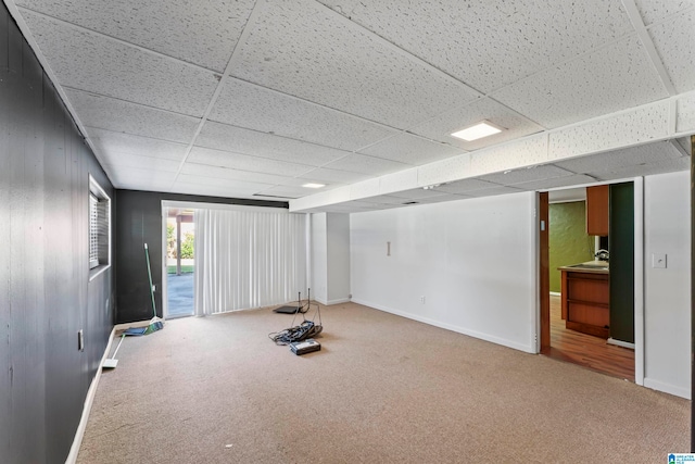 workout area featuring carpet and a drop ceiling