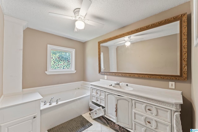 bathroom featuring tile patterned floors, a tub, vanity, a textured ceiling, and ceiling fan