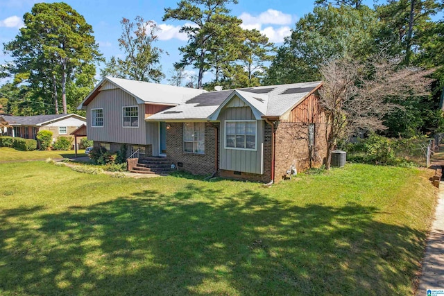 view of front of home featuring cooling unit and a front yard