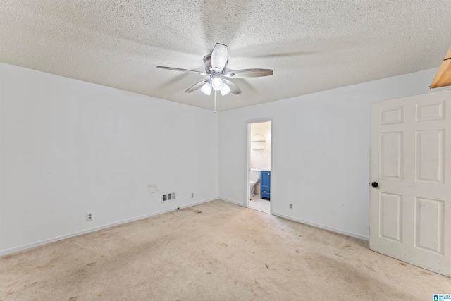 carpeted spare room featuring a textured ceiling and ceiling fan