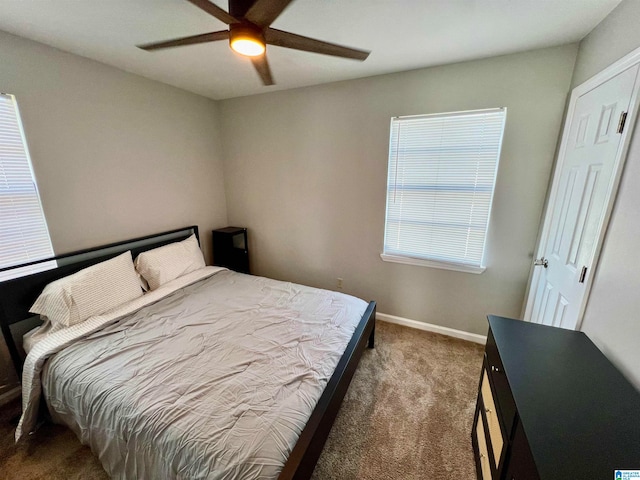 bedroom featuring dark carpet and ceiling fan