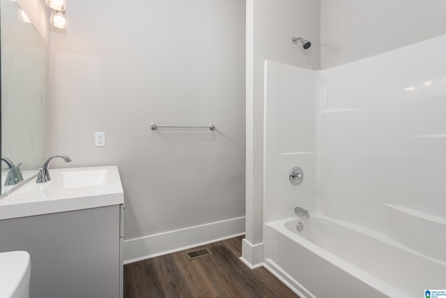 full bathroom with vanity, hardwood / wood-style flooring, toilet, and shower / bath combination