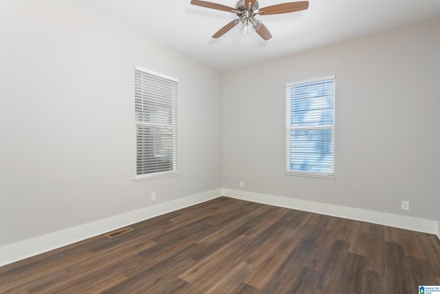 spare room featuring dark hardwood / wood-style floors and ceiling fan