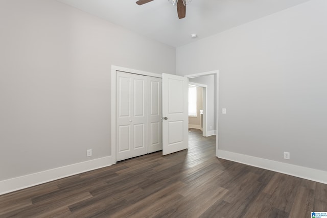 unfurnished bedroom featuring dark hardwood / wood-style floors, a closet, and ceiling fan