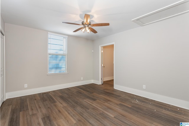 empty room featuring ceiling fan and dark hardwood / wood-style flooring