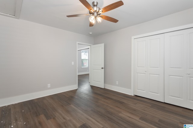 unfurnished bedroom with a closet, dark wood-type flooring, and ceiling fan