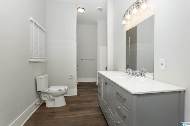 bathroom featuring toilet, hardwood / wood-style floors, and vanity