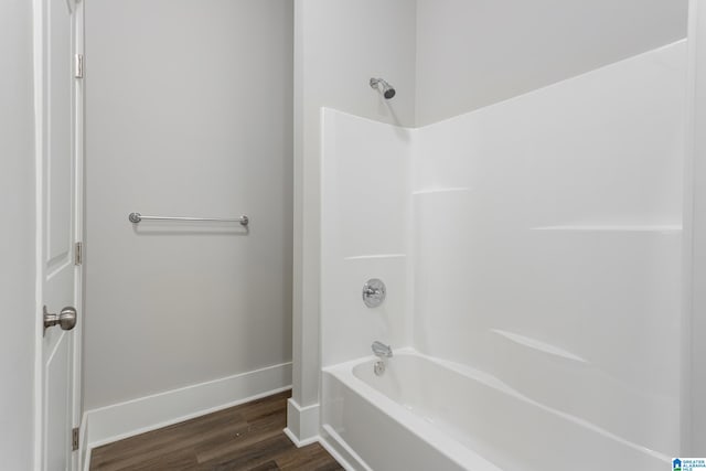 bathroom featuring bathing tub / shower combination and wood-type flooring