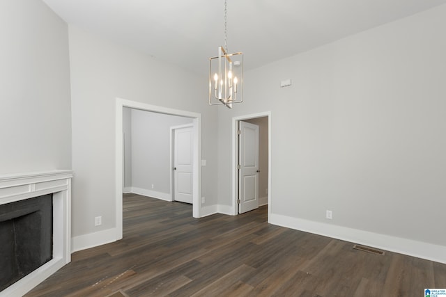 8321 Division Ave, Birmingham, AL 35206 - unfurnished dining area with visible vents, baseboards, dark wood finished floors, a fireplace, and a notable chandelier