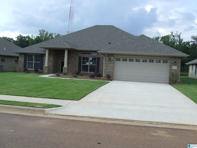 view of front facade with cooling unit, a front lawn, and a garage