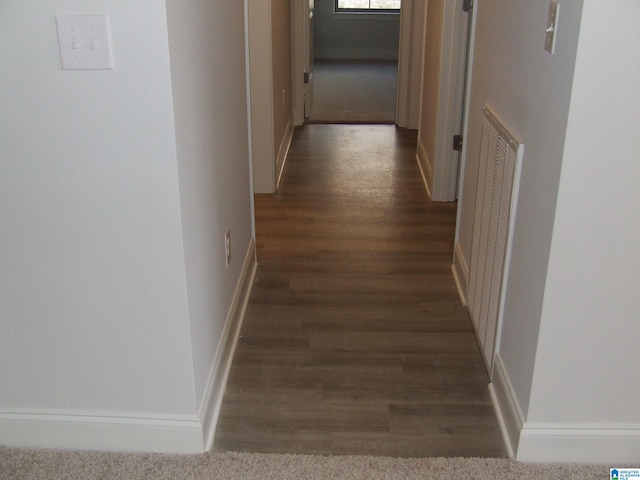 corridor with dark hardwood / wood-style floors