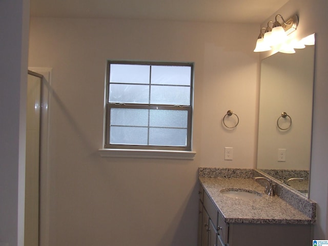 bathroom featuring vanity and an enclosed shower