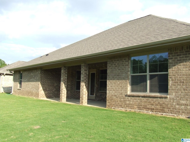 rear view of house featuring a yard