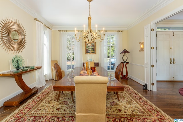 dining space featuring dark wood-type flooring, crown molding, and an inviting chandelier