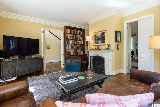 living room with crown molding, dark wood finished floors, stairway, and baseboards
