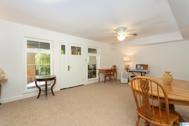 interior space with light colored carpet, ceiling fan, and baseboards