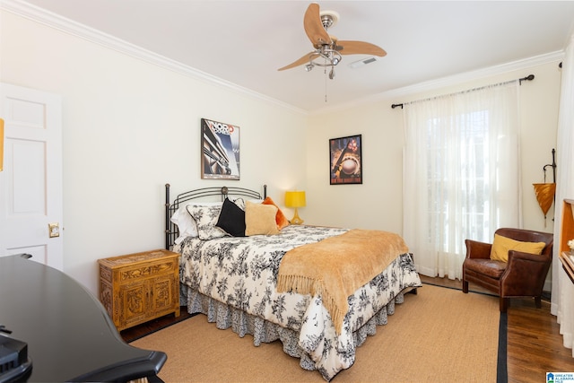 bedroom featuring crown molding, wood-type flooring, and ceiling fan