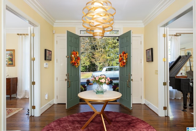 foyer featuring dark wood-type flooring, crown molding, and a chandelier