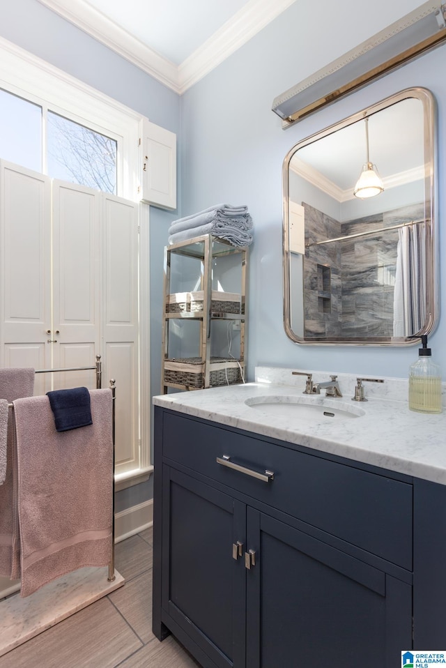 bathroom featuring hardwood / wood-style floors, vanity, crown molding, and walk in shower