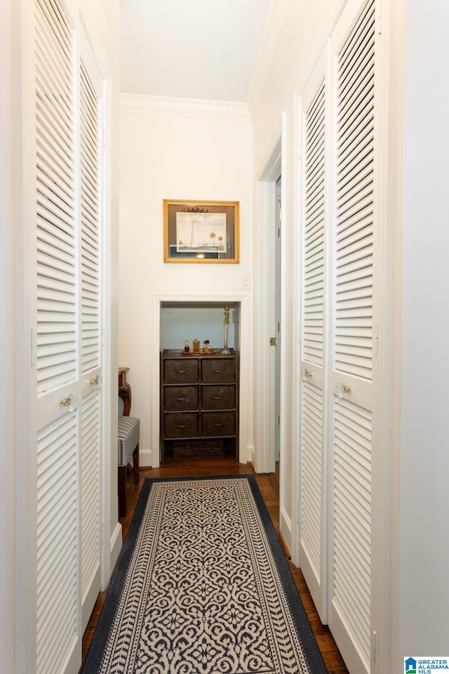 hallway with crown molding and dark wood-type flooring