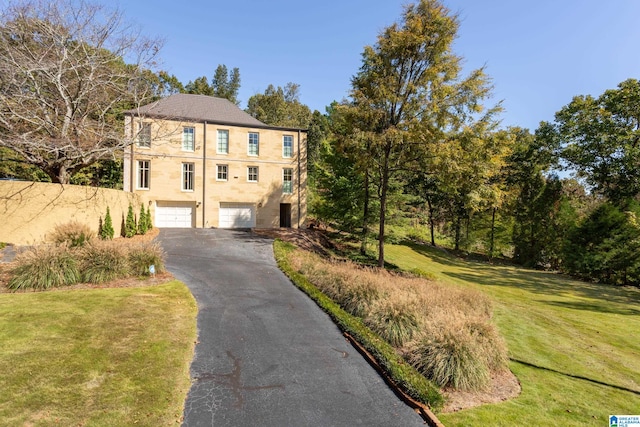 view of front of property featuring a garage and a front lawn