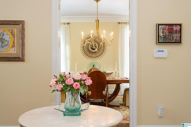 dining space with ornamental molding and an inviting chandelier